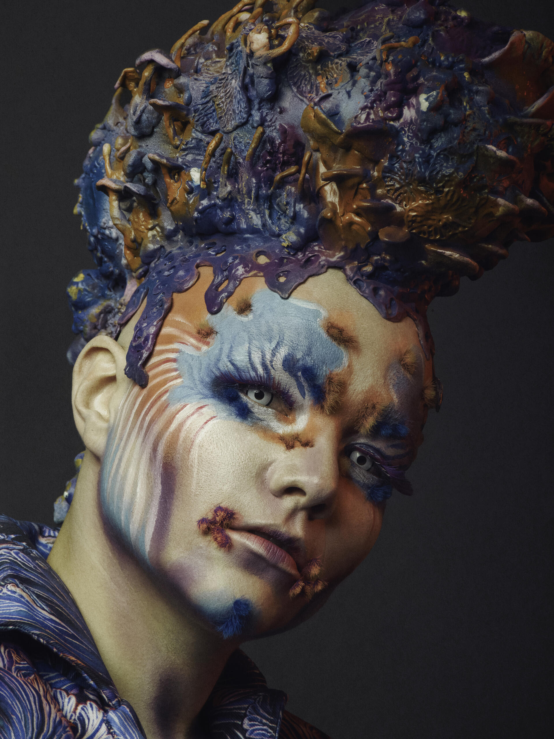 Portrait with colourful make-up and an artistic hairstyle.