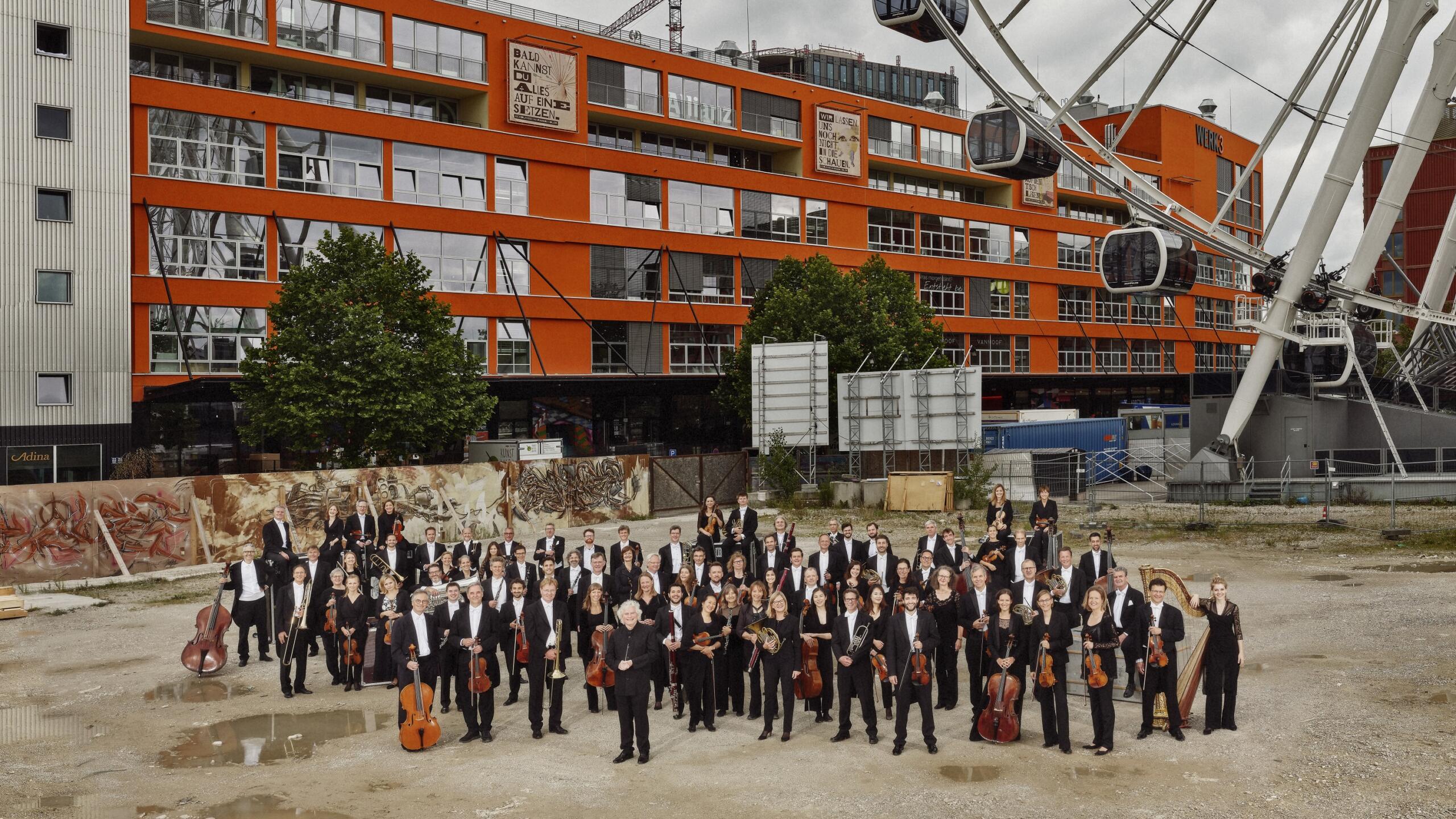 An orchestra stands on a building site