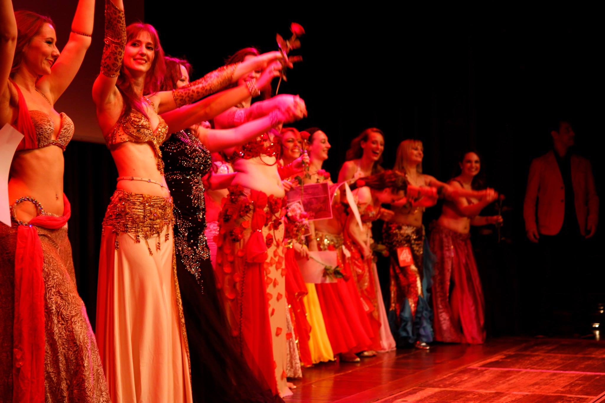 A row of women in belly dance costumes