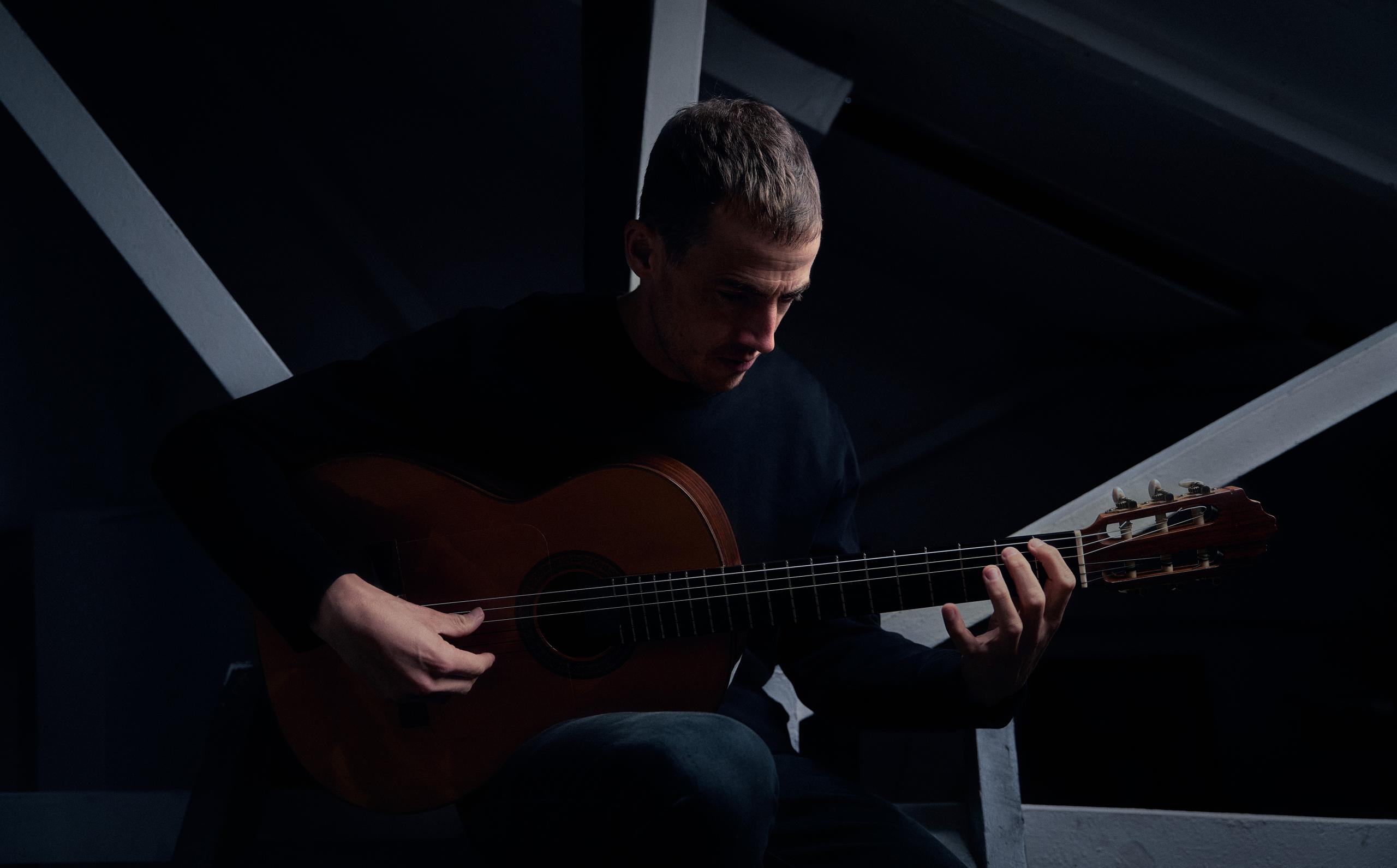 Portrait of musician Cunningham on acoustic guitar