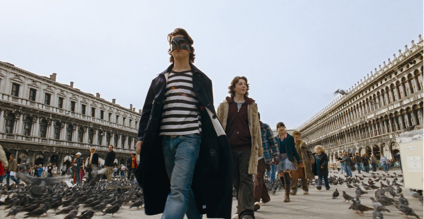 Derr Herr der Diebe trägt eine schwarze Schnabelmaske und läuft mit seinen Freunden durch Venedig.