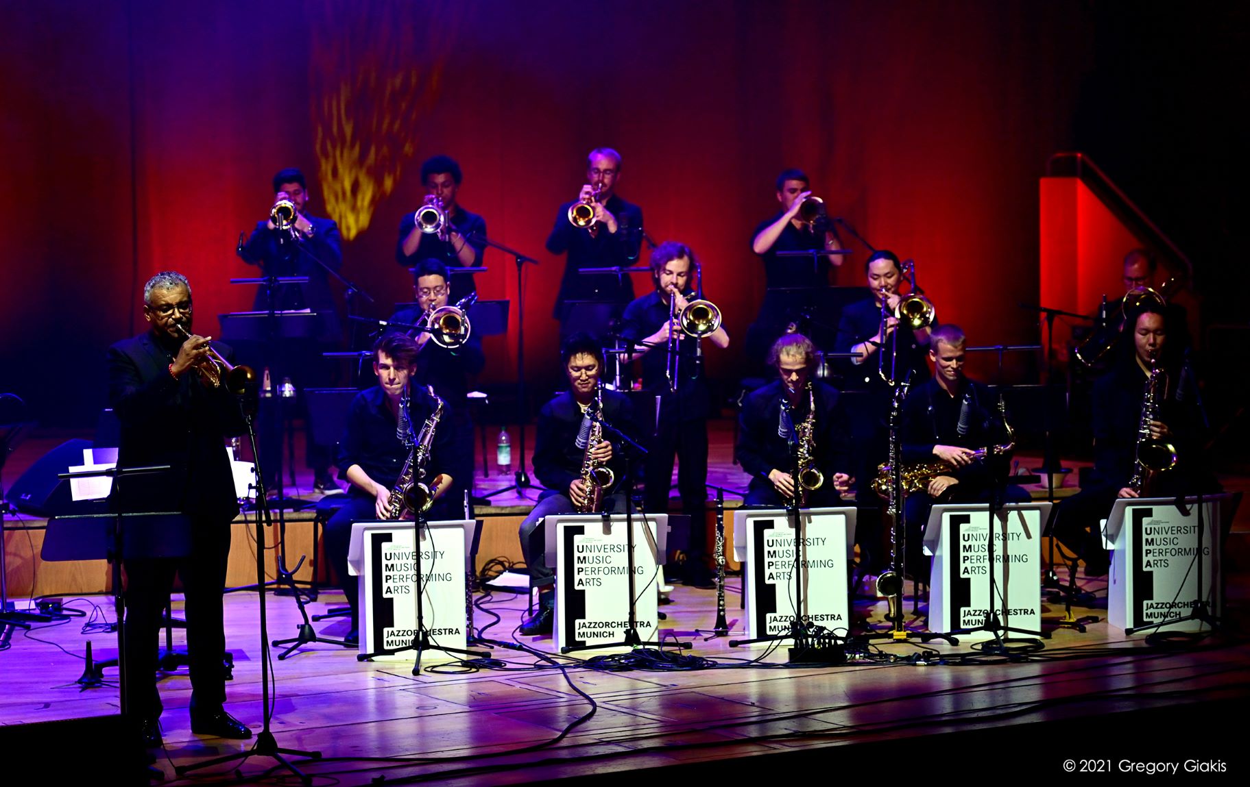 Brass ensemble on a red illuminated stage