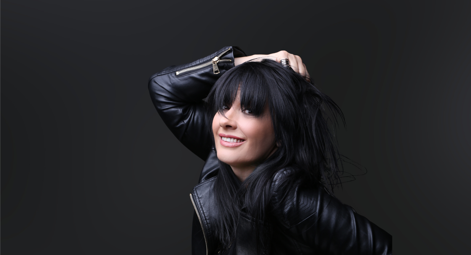 Portrait of woman in black leather jacket and dark hair