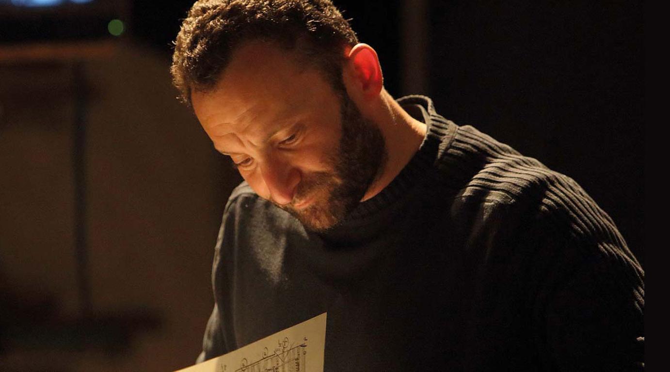 Close-up of Kirill Petrenko, engrossed in a sheet of music
