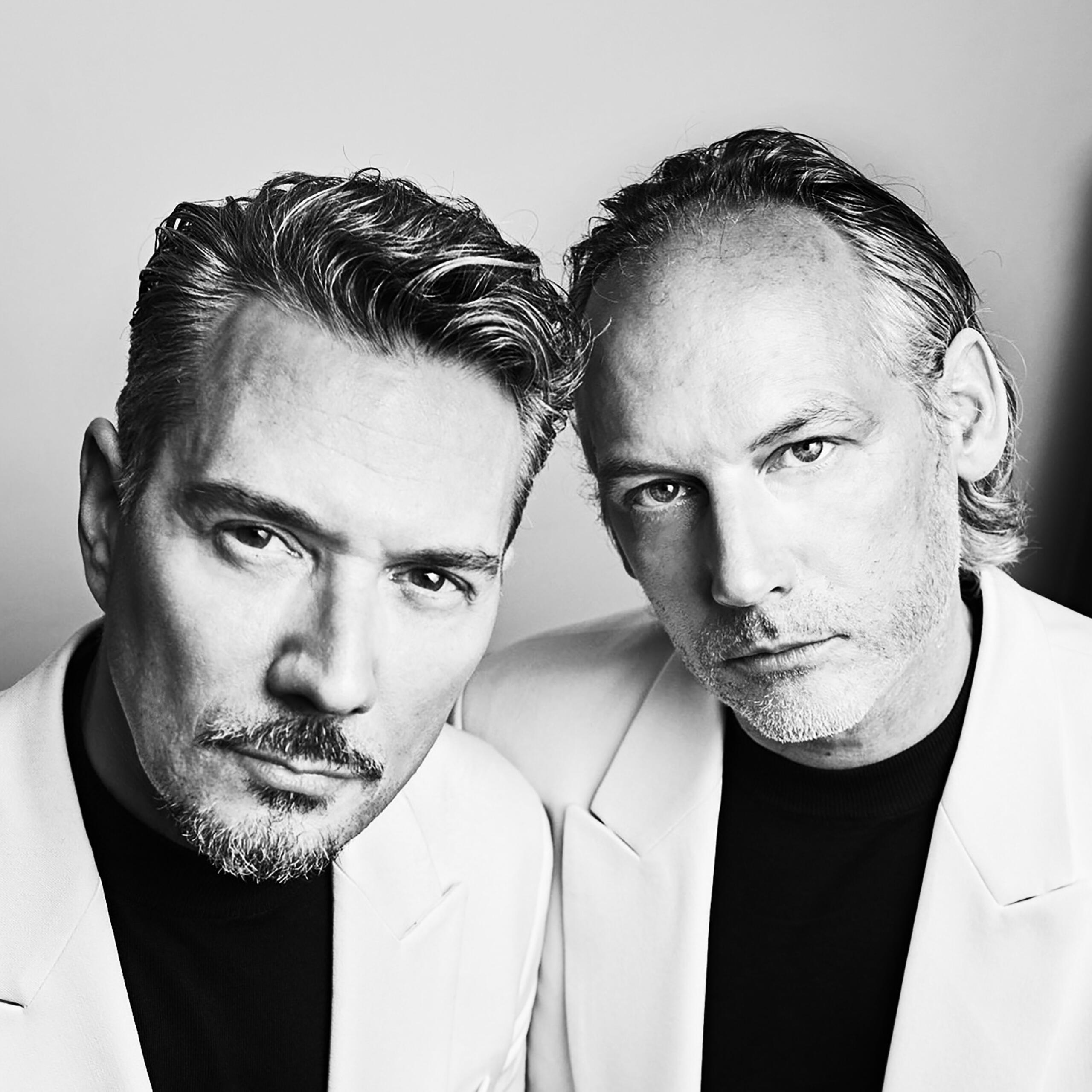 Black and white portrait of two men.