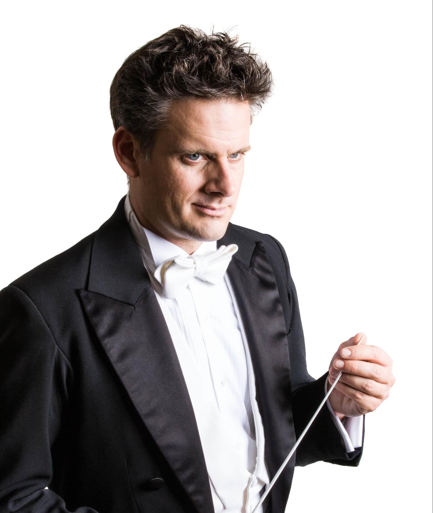 Portrait shot of conductor Philippe Jordan holding his baton in his hands

