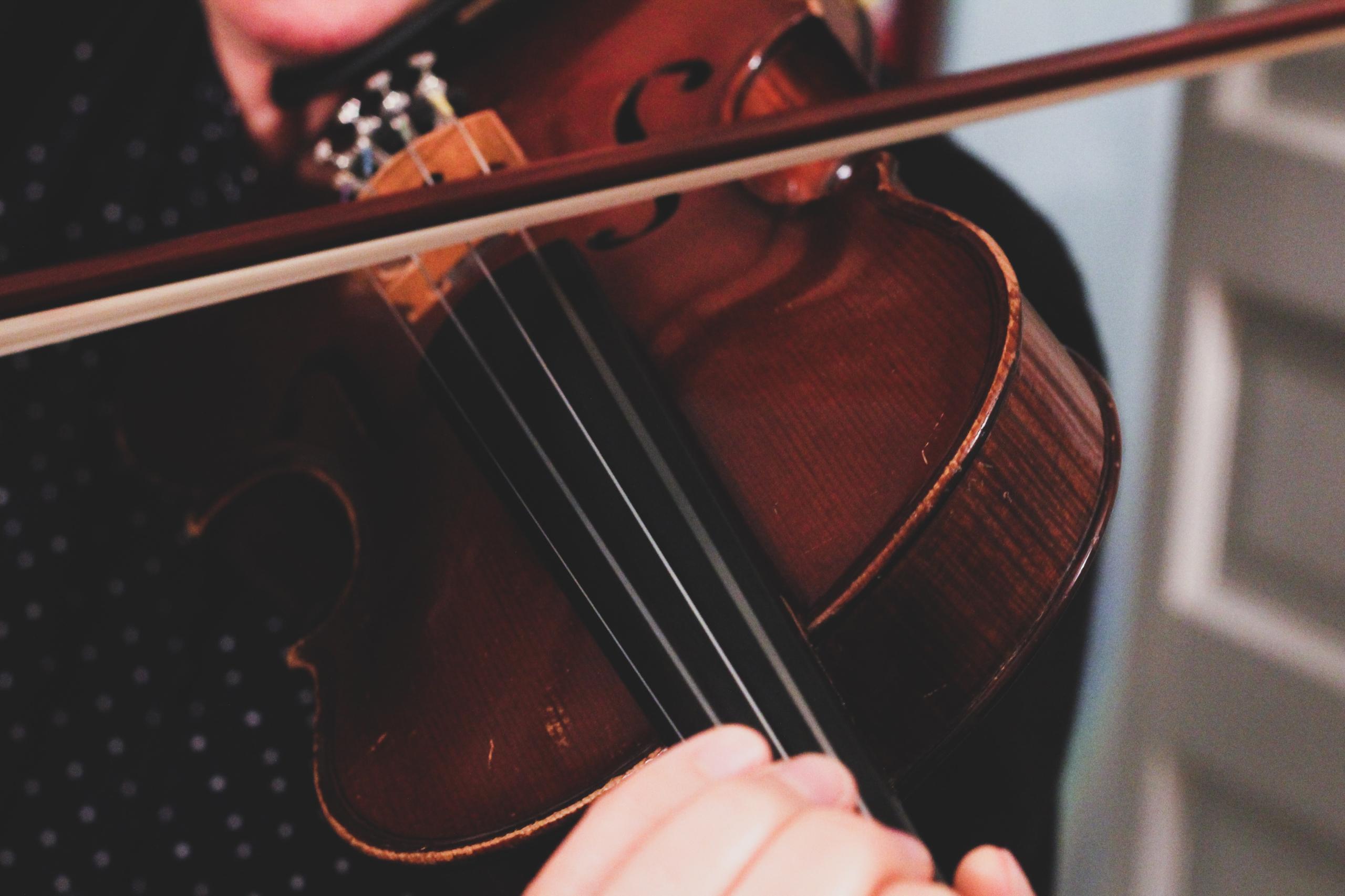 Close-up of a viola being played.
